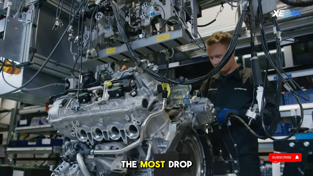 Inline‑six engine on an assembly stand with technician, wiring and tooling in a workshop