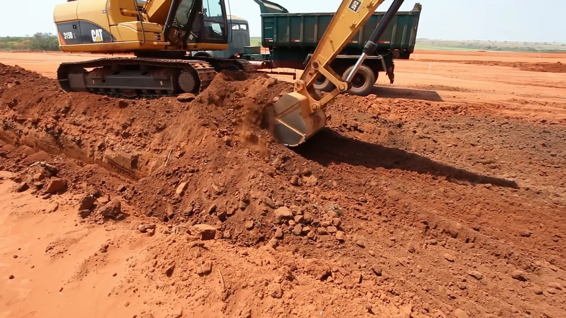 Excavator digging soil with heavy steel bucket