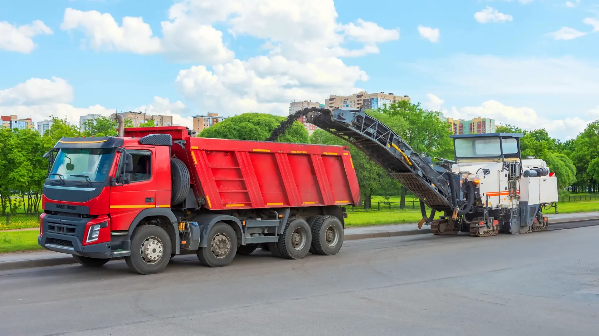 Asphalt milling machine removing old pavement layer
