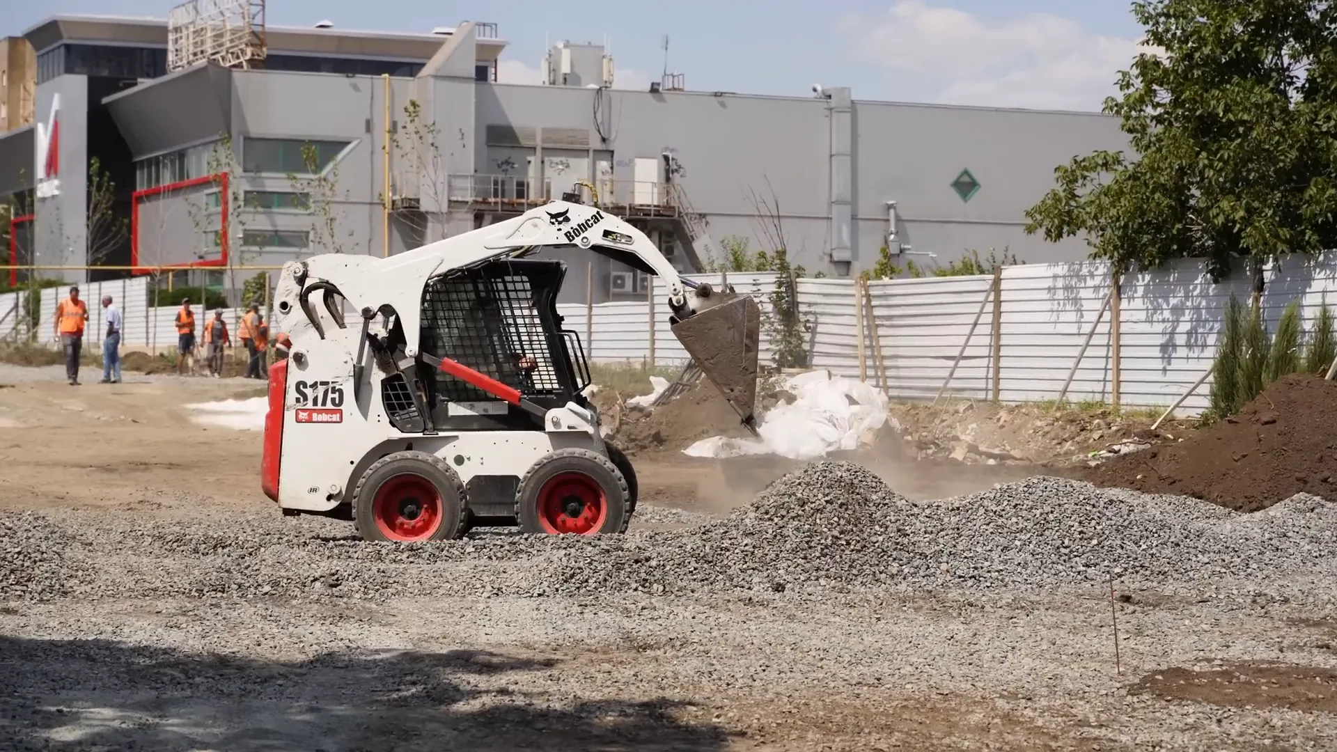 Skid steer loader with multiple attachments