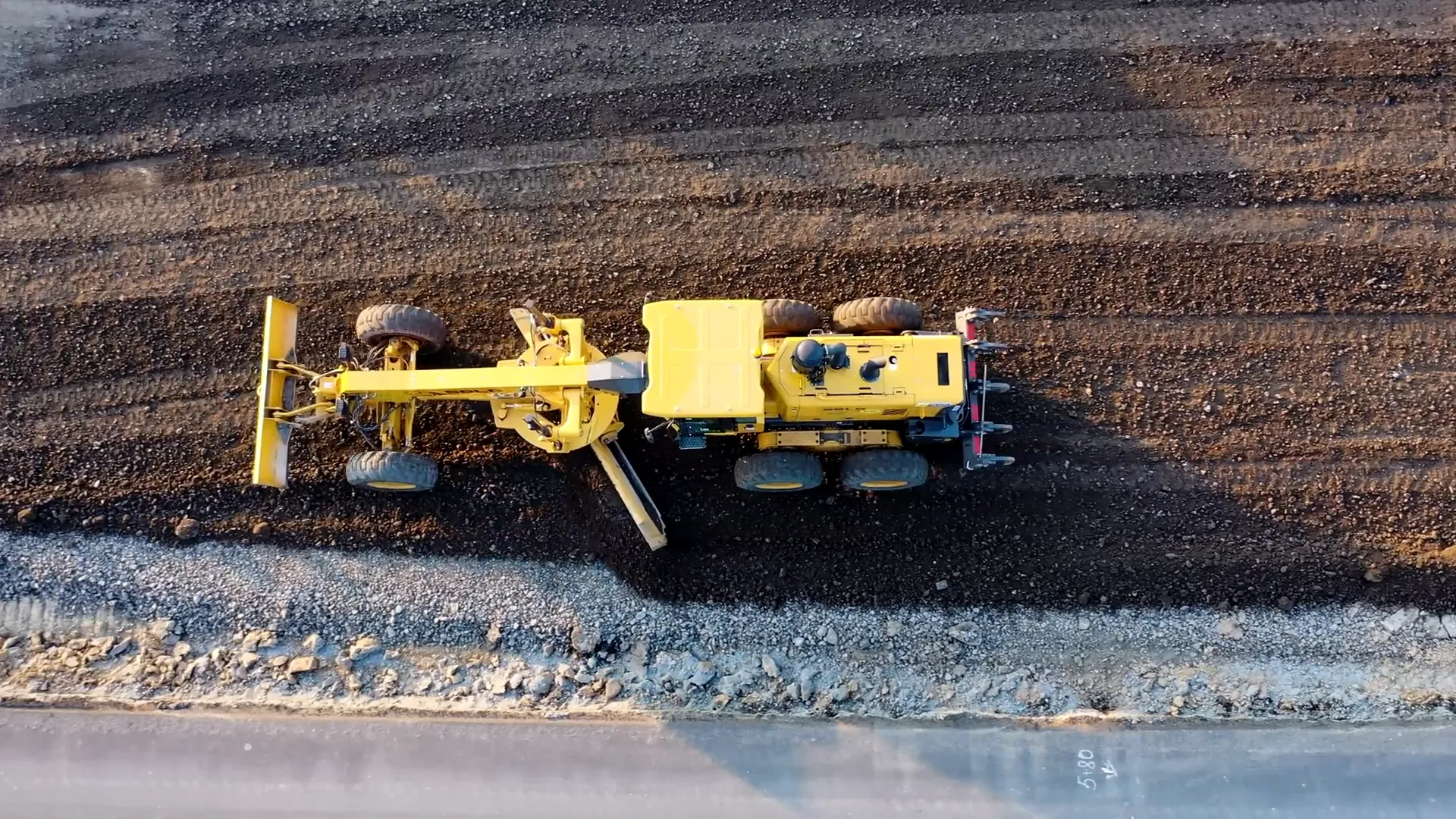 Grader leveling a road surface