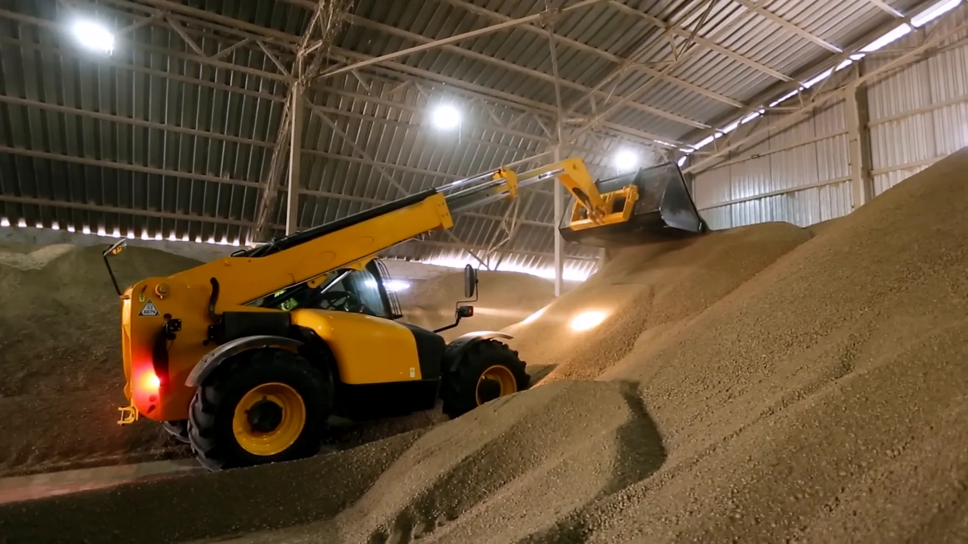 Telescopic handler with pallet forks on construction site