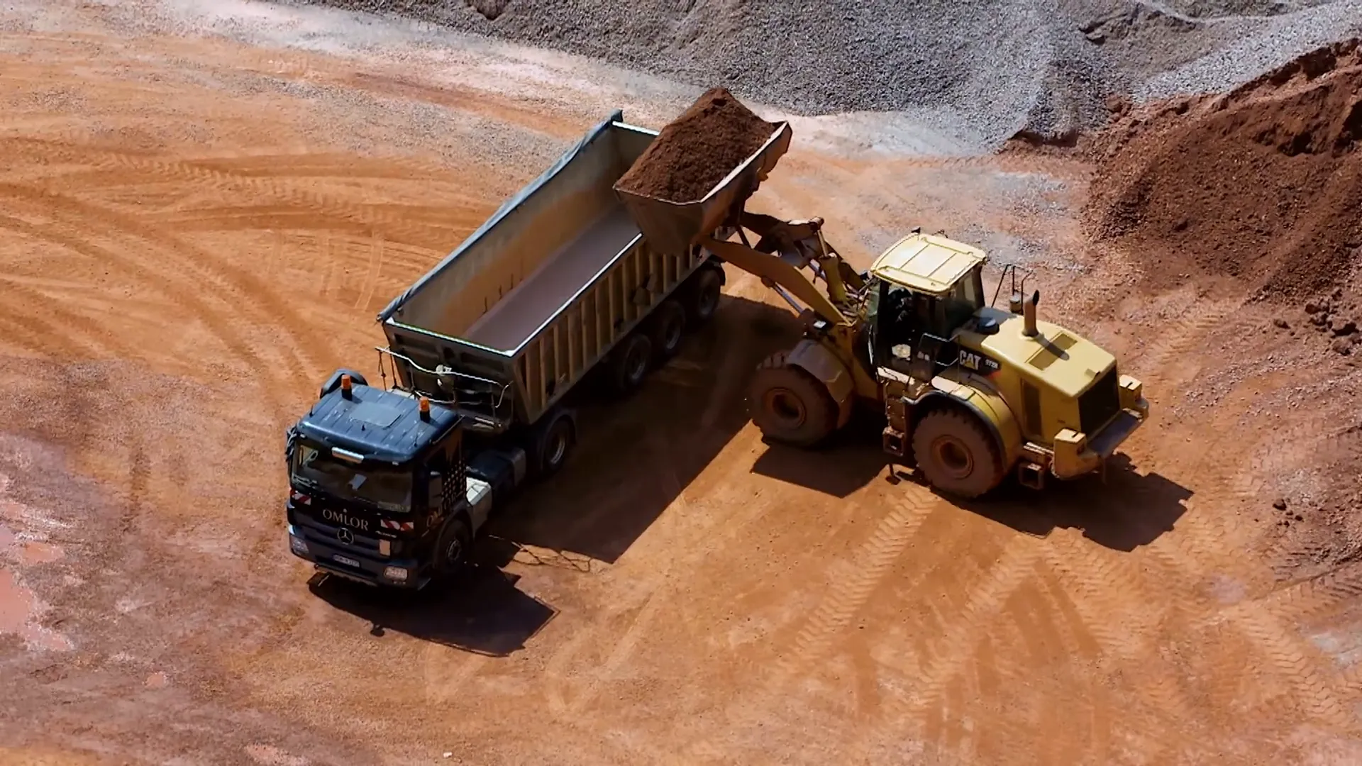 Articulated loader carrying soil across a construction site