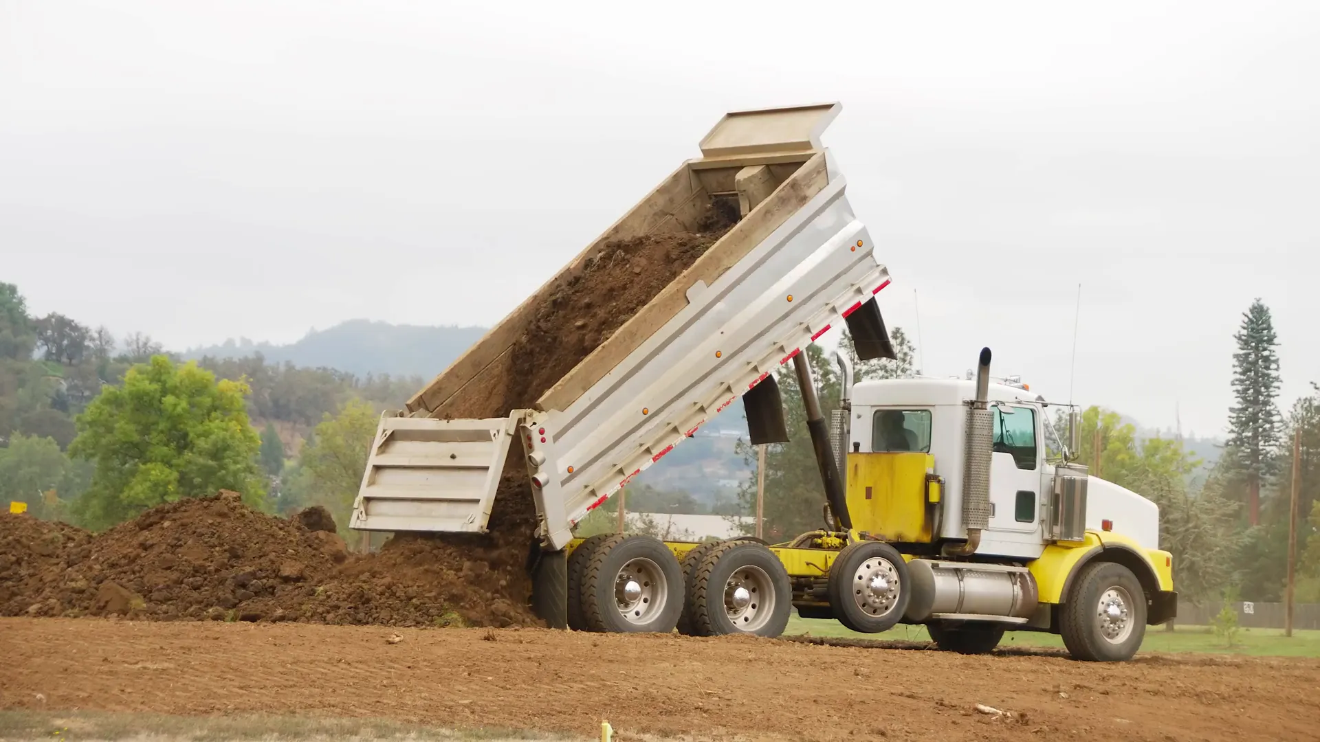 Dump truck unloading soil