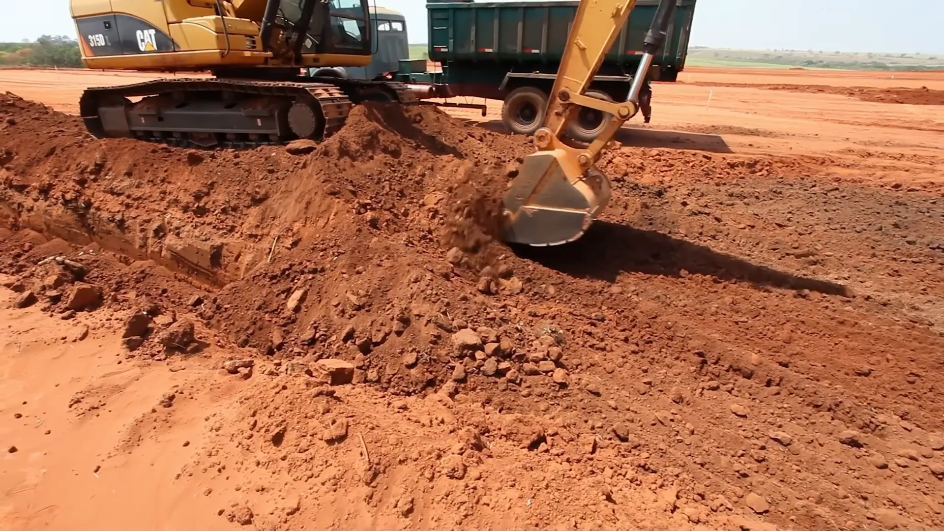 Excavator with steel bucket digging soil