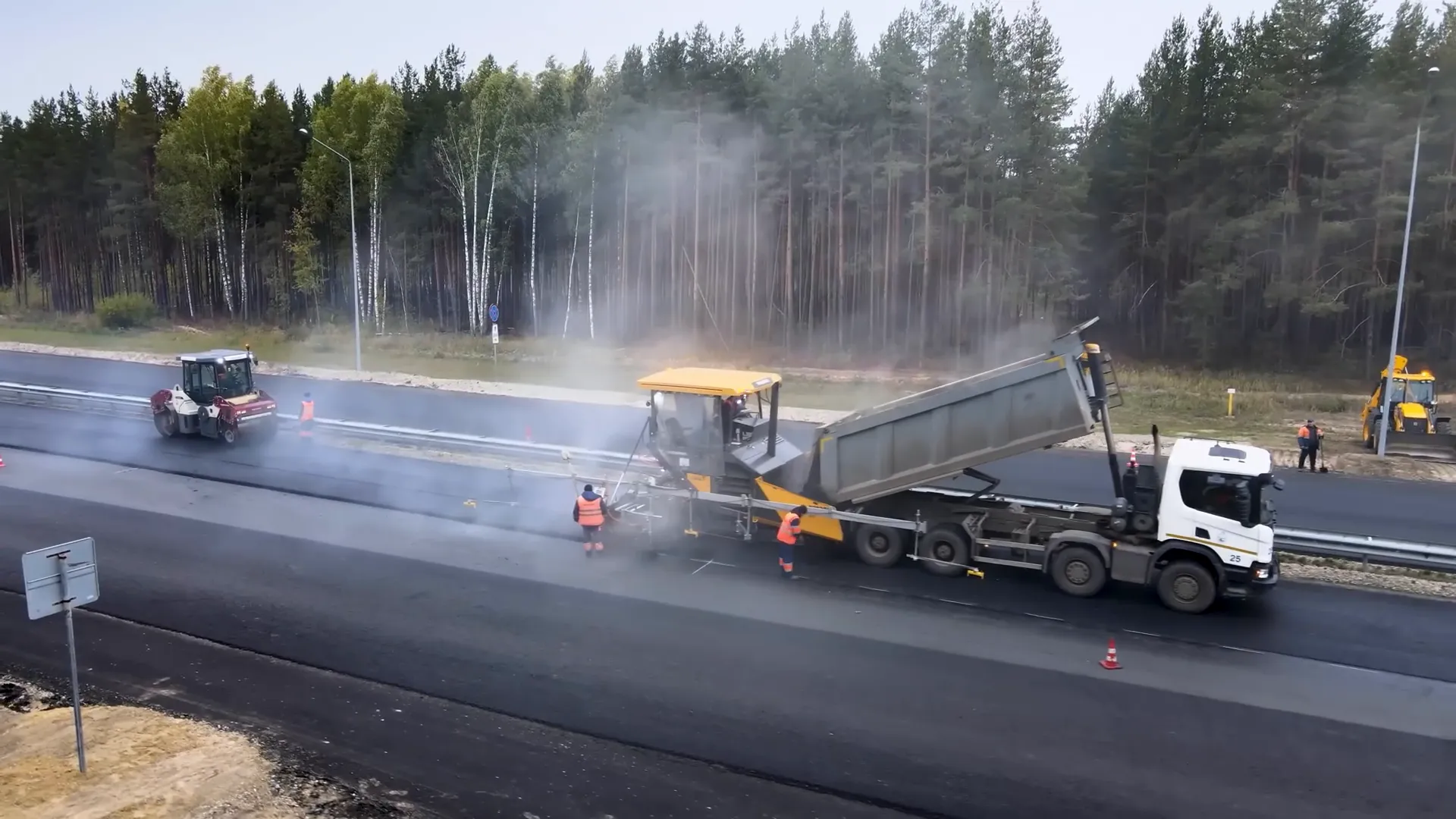 Asphalt paver laying road surface