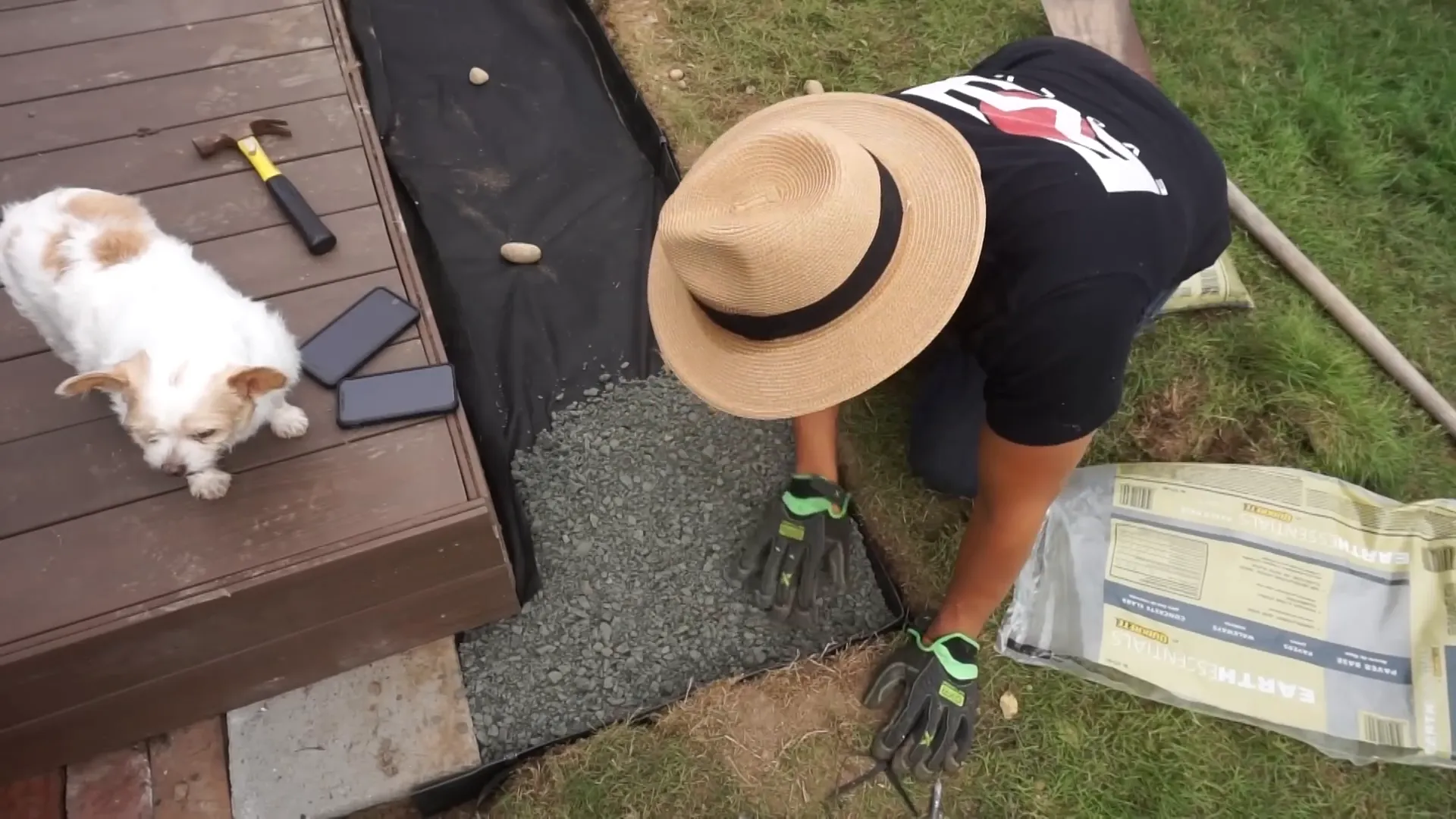 Spreading paver base with bow rake