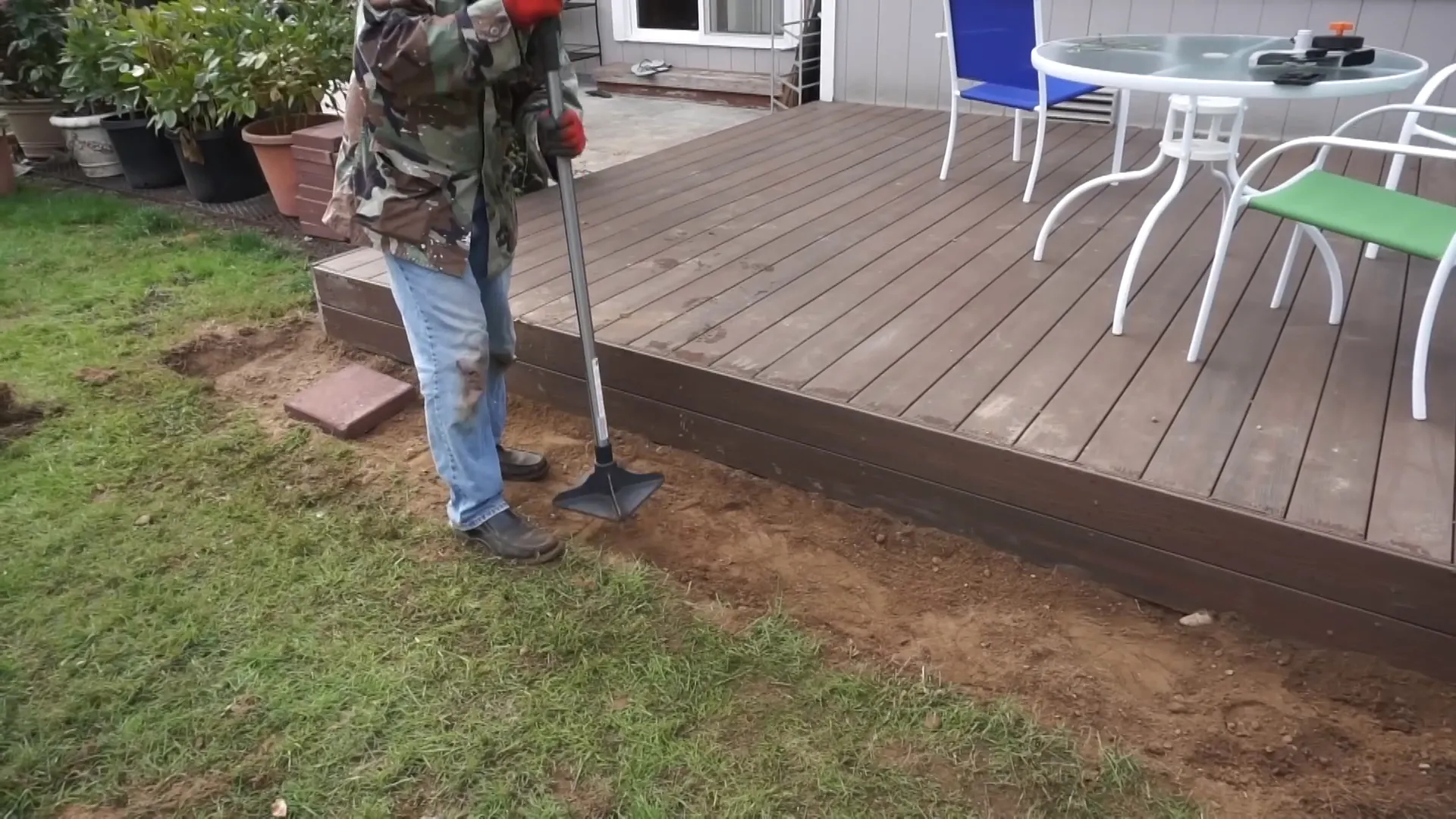 Using tamper tool to compact soil