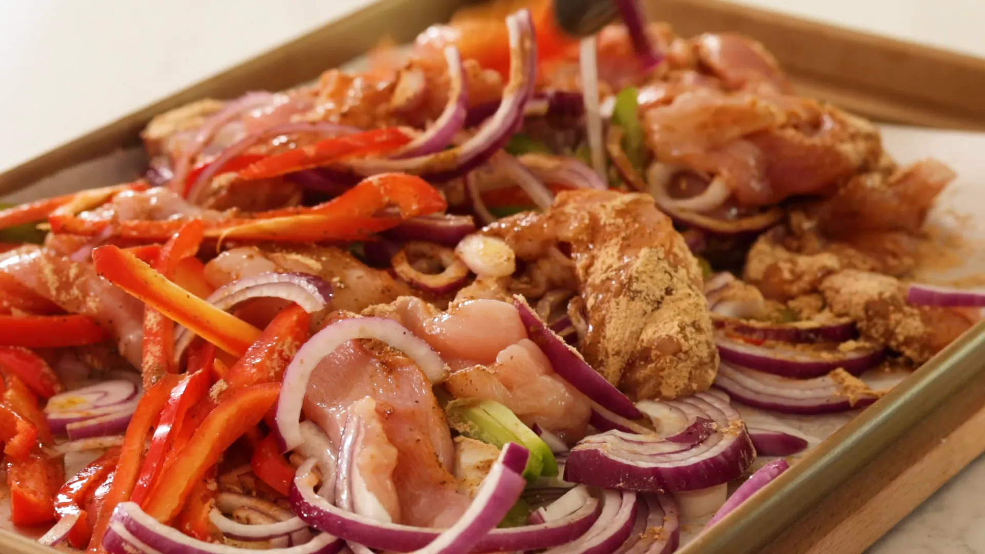 Full pan of chicken and veggies before cooking.