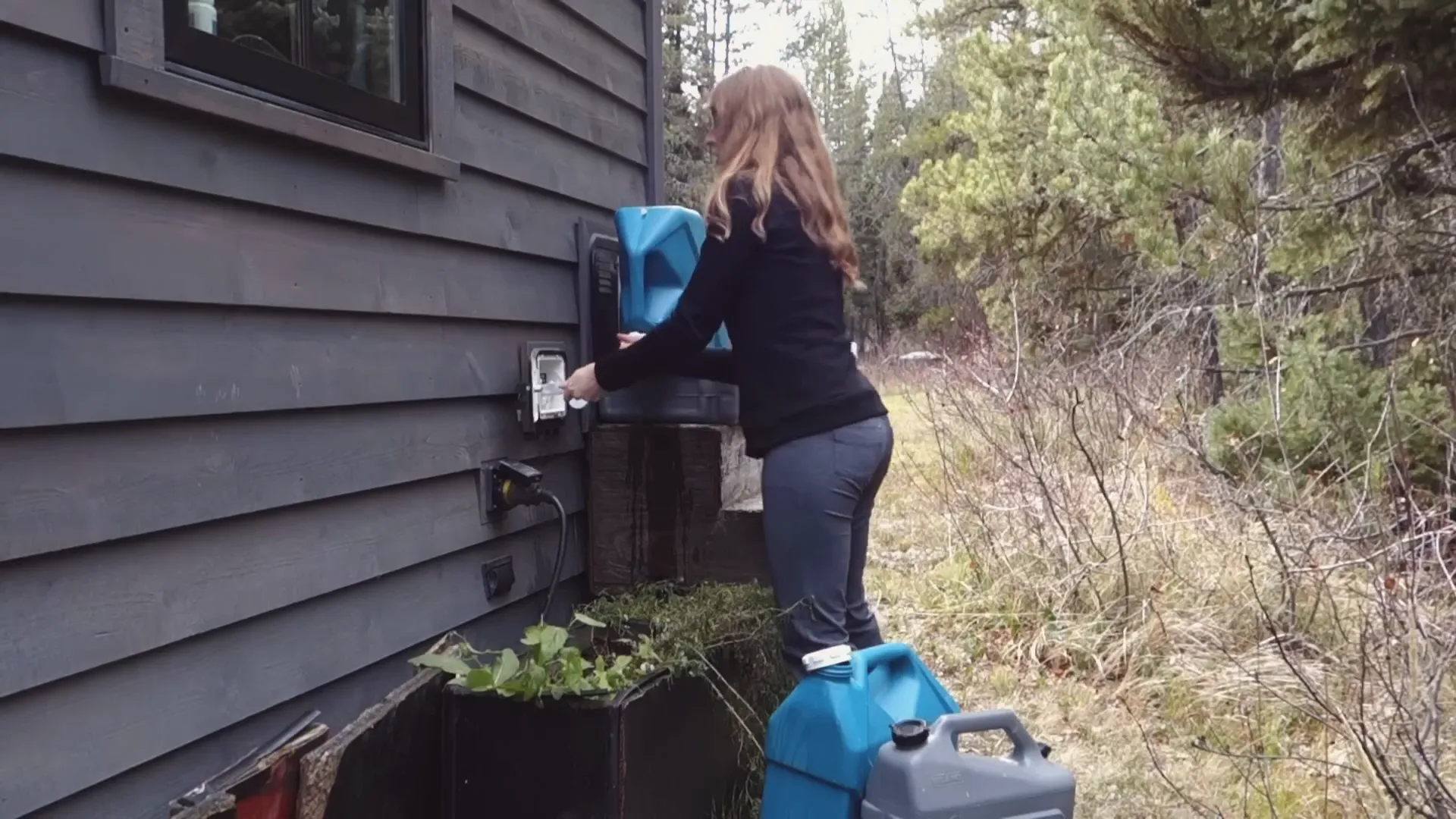 Ariel filling water jugs