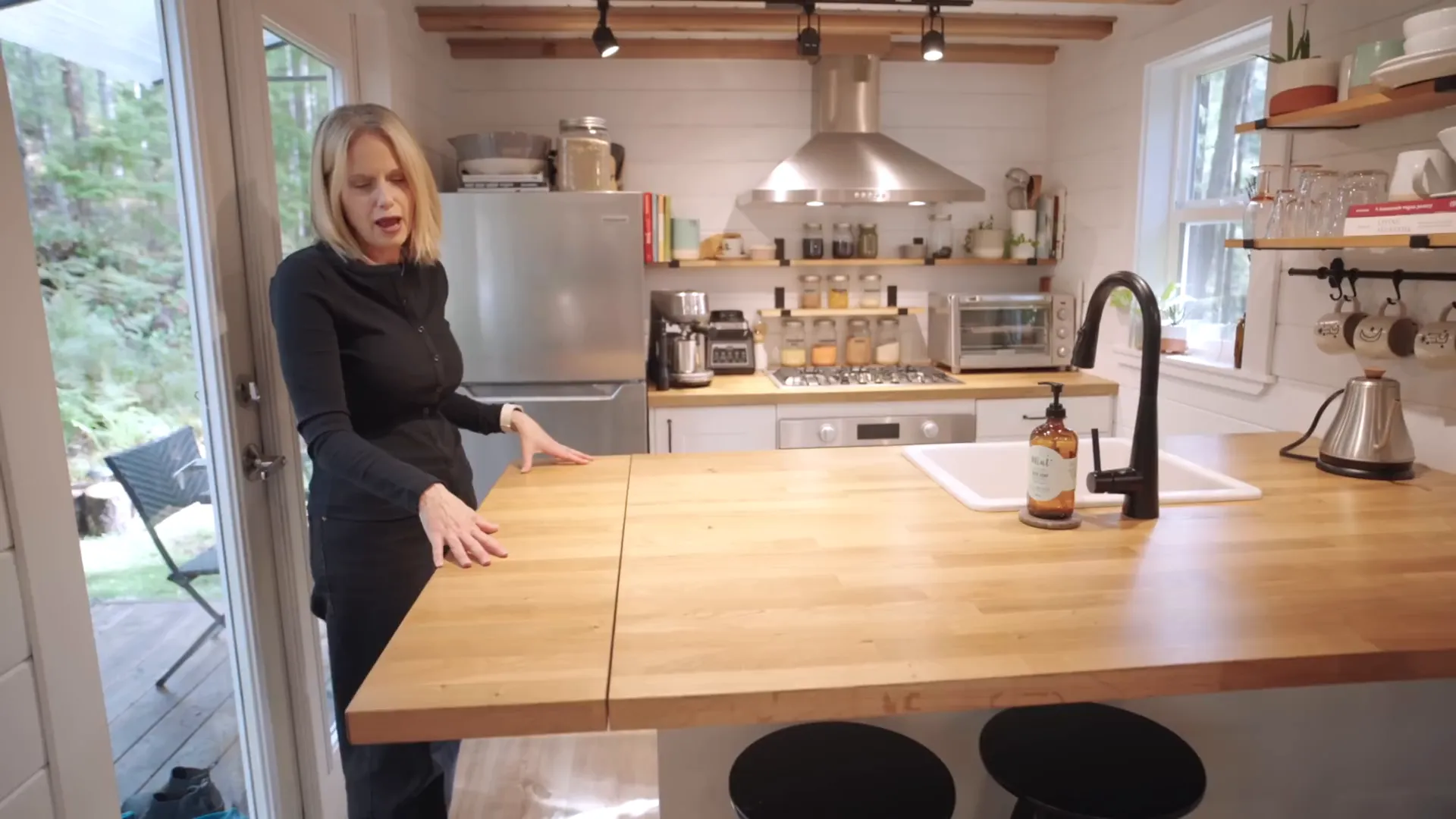 Amber demonstrating the multi-purpose kitchen island.