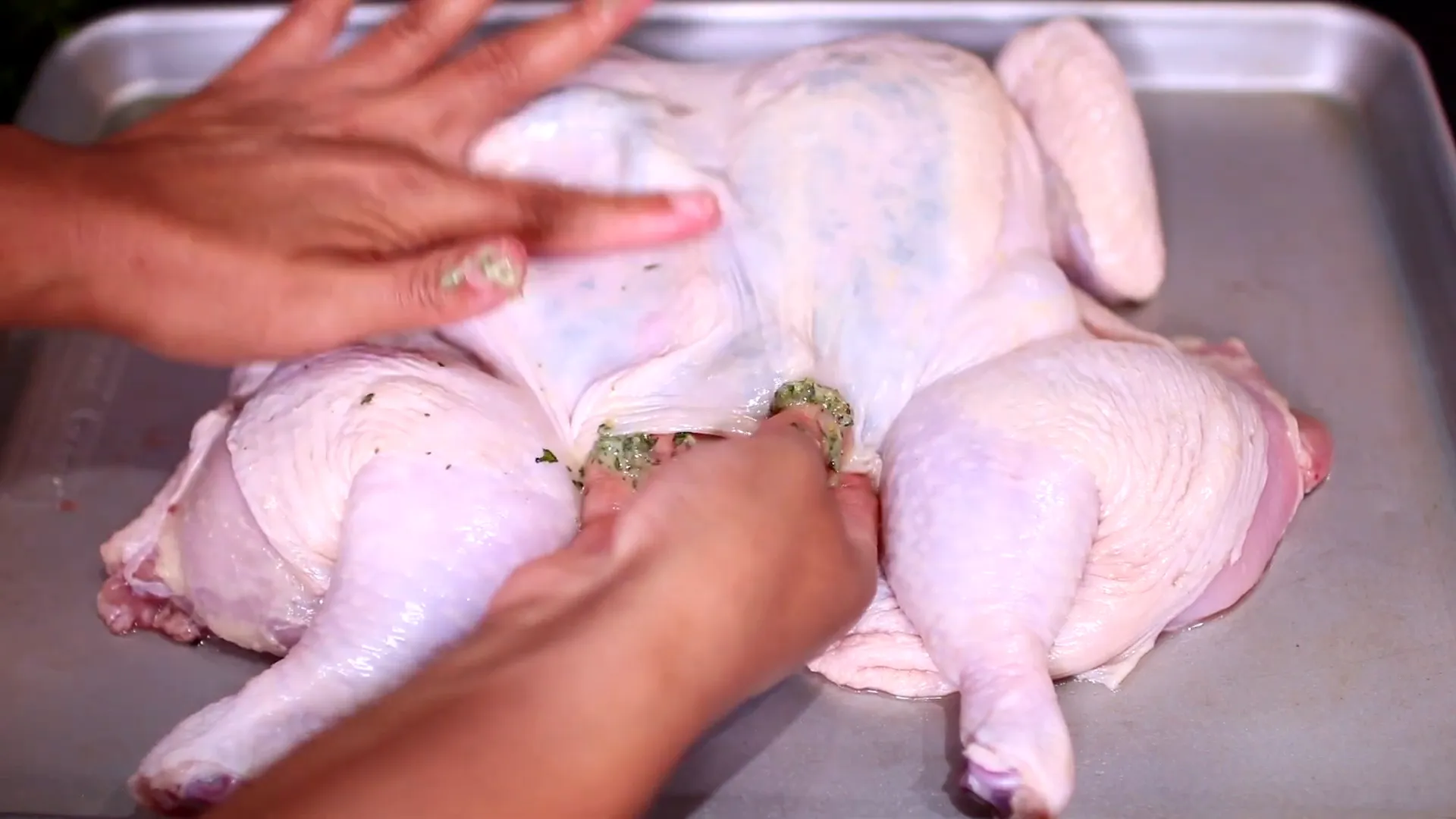 Seasoning under the skin of the chicken