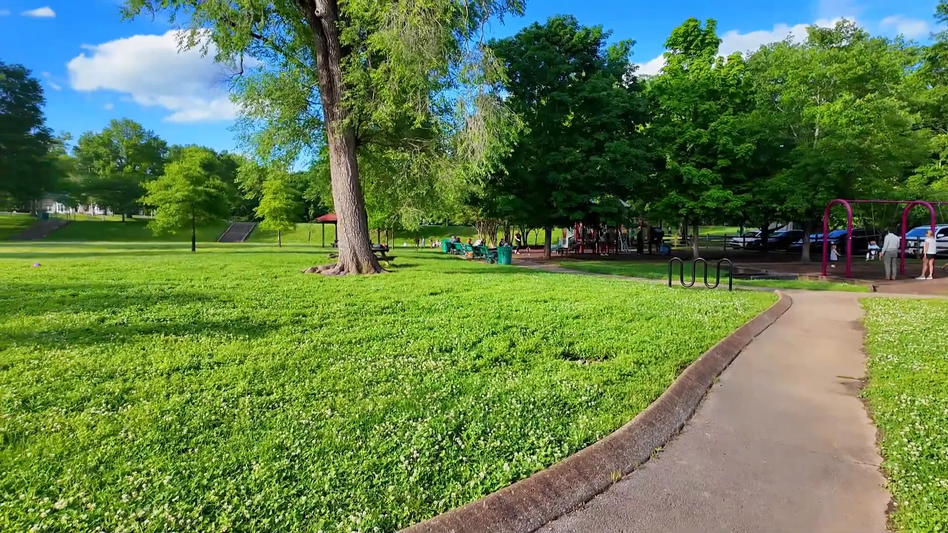 Pocket park with historic school gates and basketball hoop