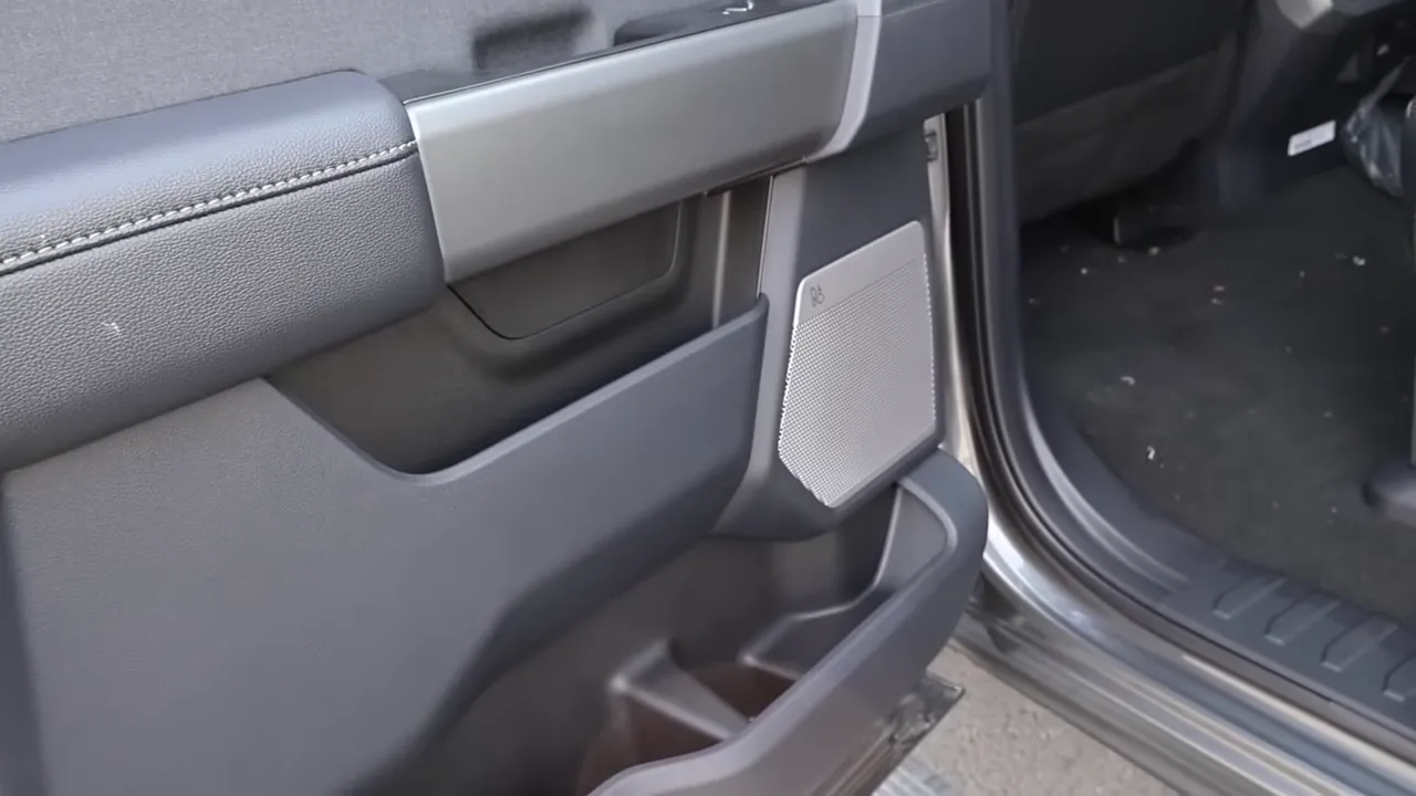 Door speaker grille and storage pocket showing Bang & Olufsen audio on Ford F-350 Lariat