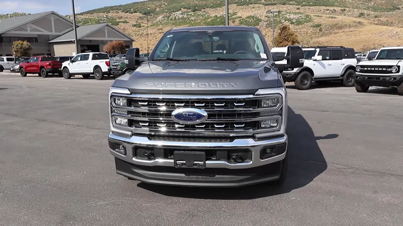 Full frontal view of 2026 Ford F-350 Lariat showing Super Duty hood letters, large chrome grille and headlight clusters