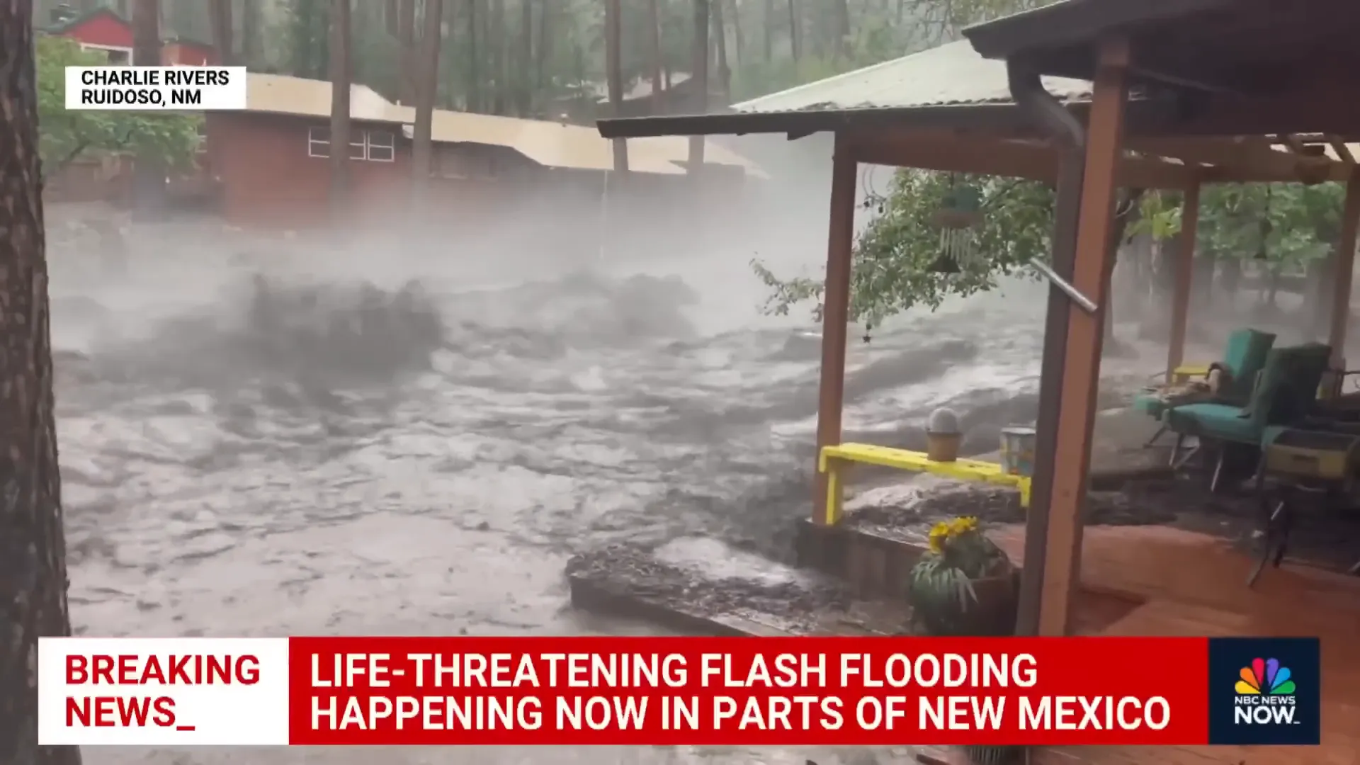 Water rushing past buildings and homes during flash flood in New Mexico