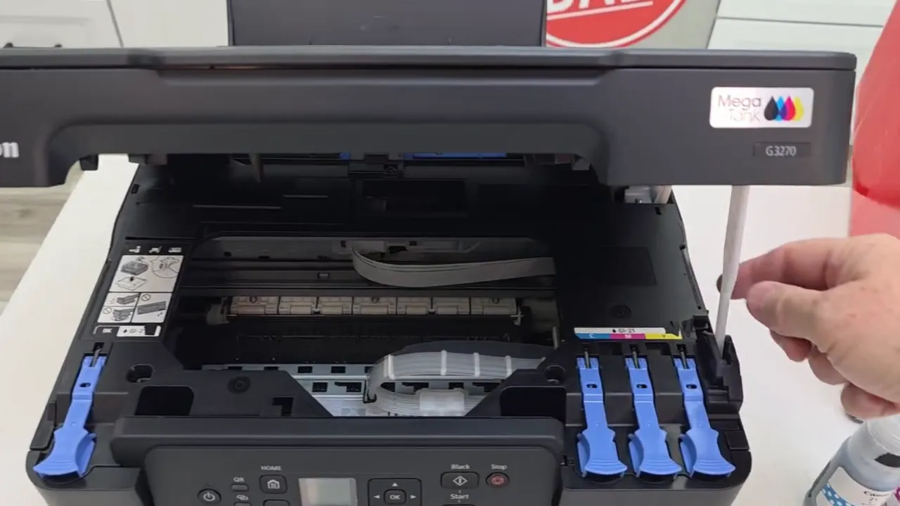 Lifting the scanner lid to reveal ink tank area