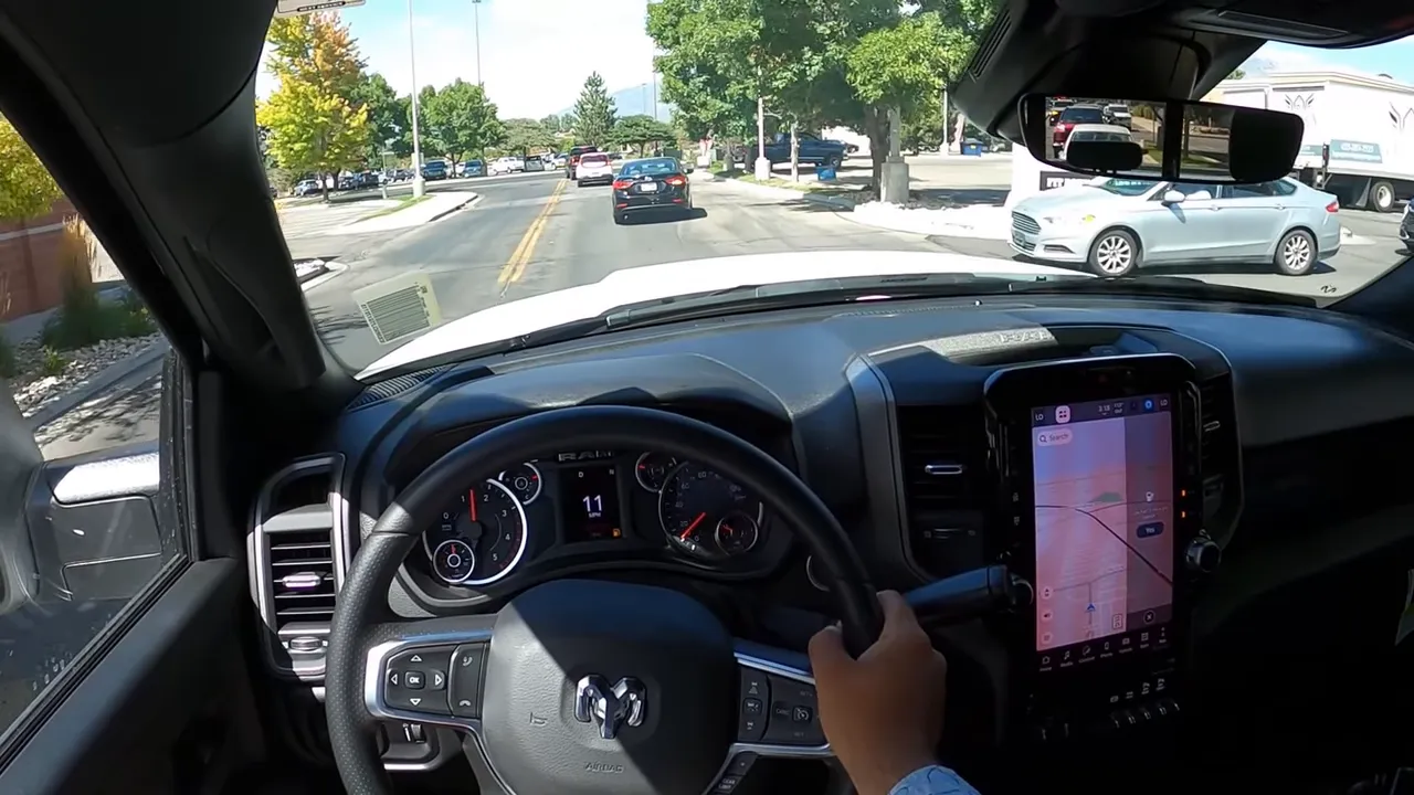 Interior driving view of Ram 2500 showing steering wheel, instrument cluster and road ahead
