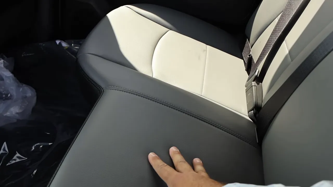 Hand touching vinyl rear bench seat in Ram 2500 Tradesman