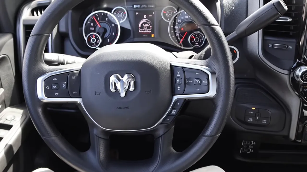 Clear Ram 2500 steering wheel showing left and right steering controls, gauges and column shifter