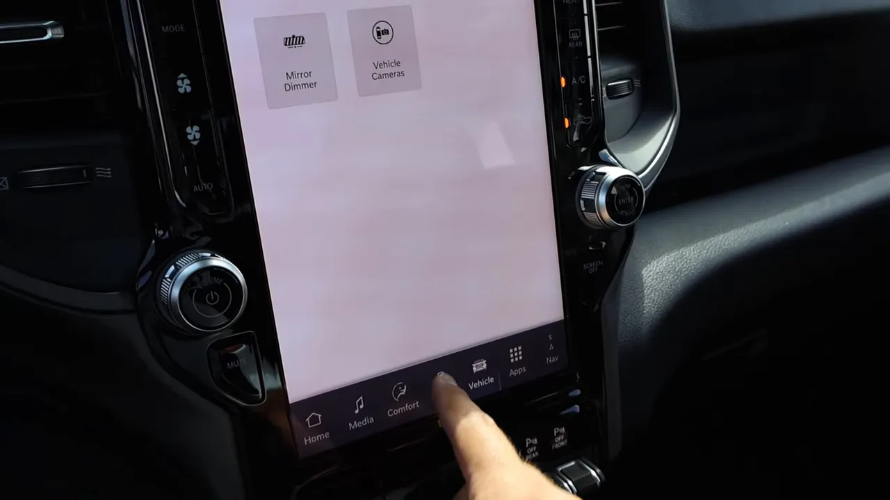 Vertical infotainment screen showing Vehicle and Mirror Dimmer tiles with finger selecting Vehicle