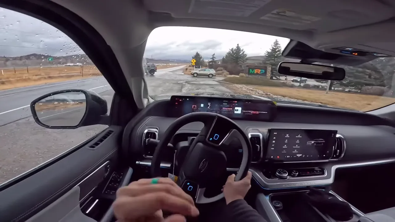 Close driver-eye view showing the Expedition’s stylized non-circular steering wheel, hands on the wheel, dashboard and road ahead