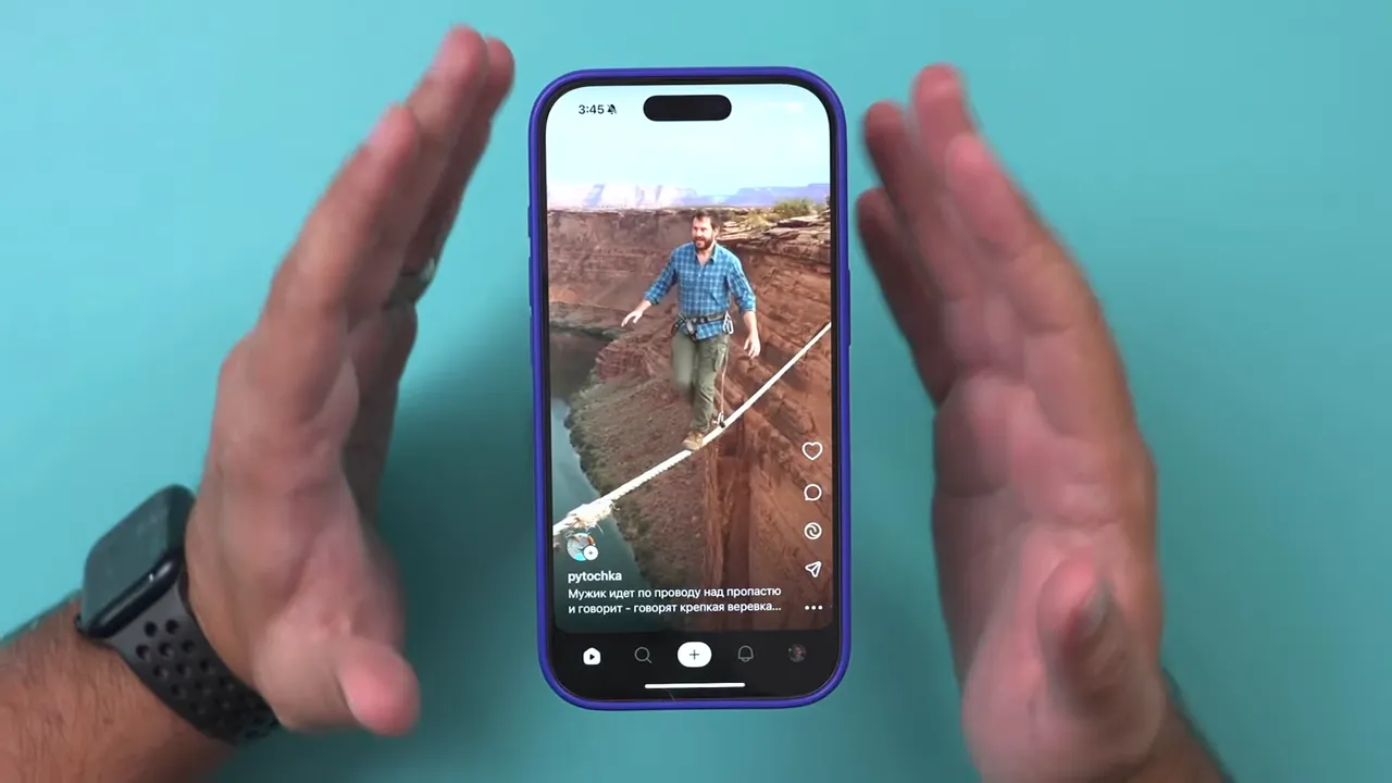 Clear portrait video of a tightrope walker shown in the Sora vertical feed on an iPhone, framed by hands.