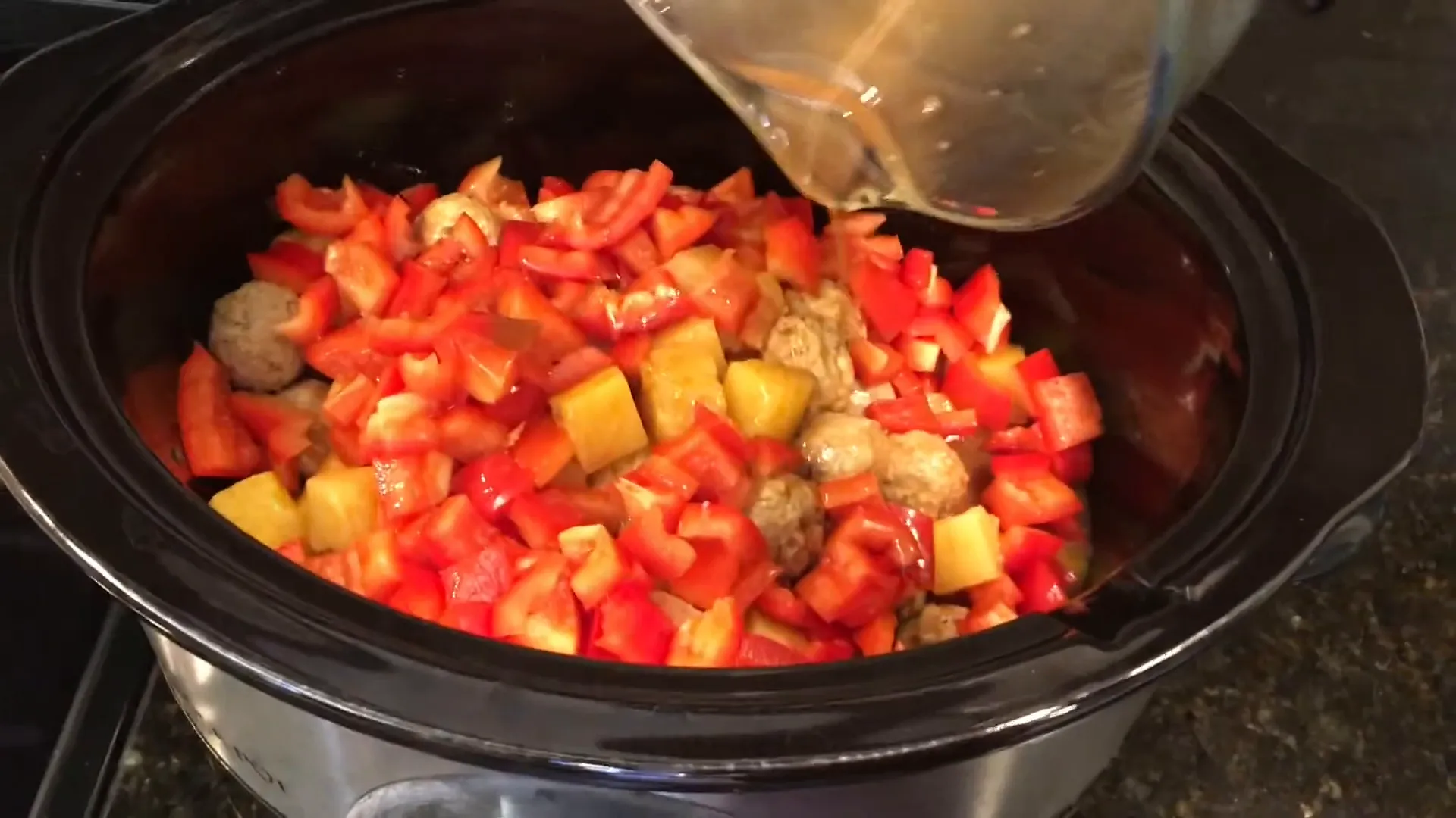 Mixing the meatballs with the sauce.