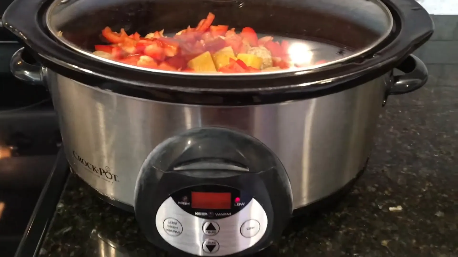 Setting the crockpot to low for cooking.