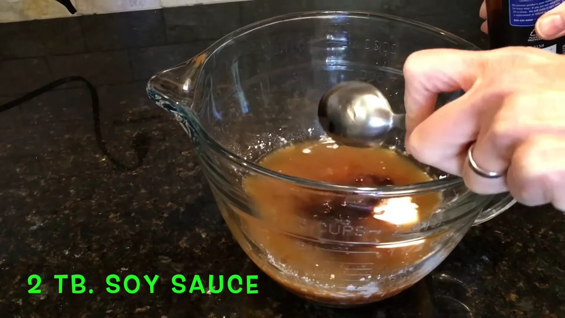Adding soy sauce to the mixture.
