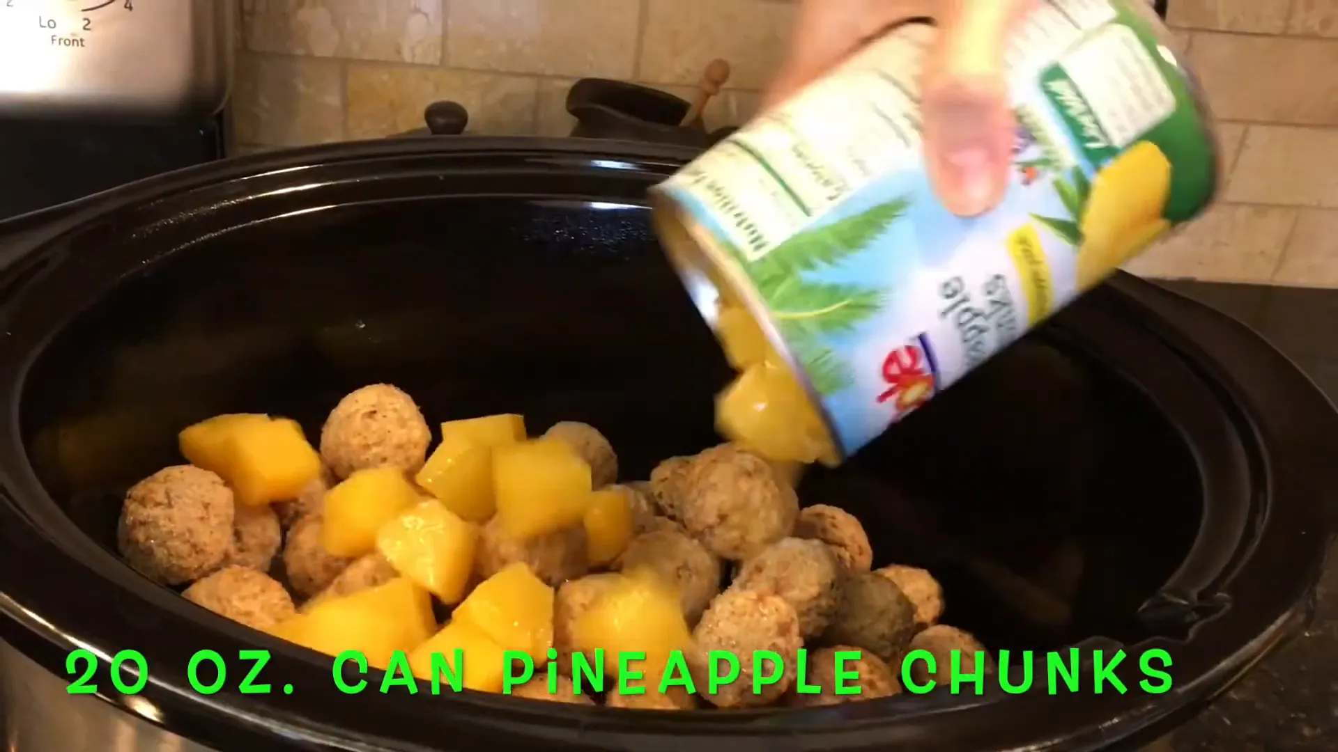 Pouring pineapple chunks over the meatballs.