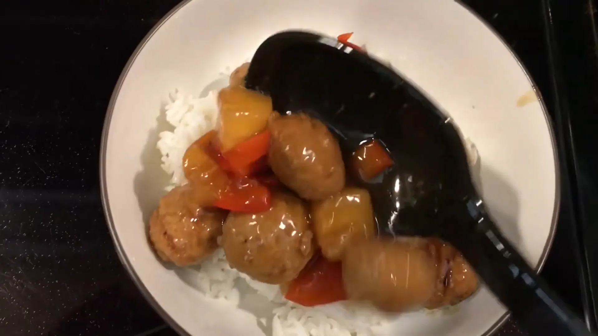 Adding steamed vegetables to the plate.