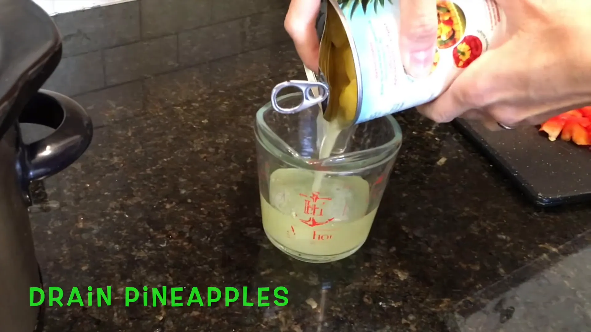 Draining pineapple juice into a bowl.