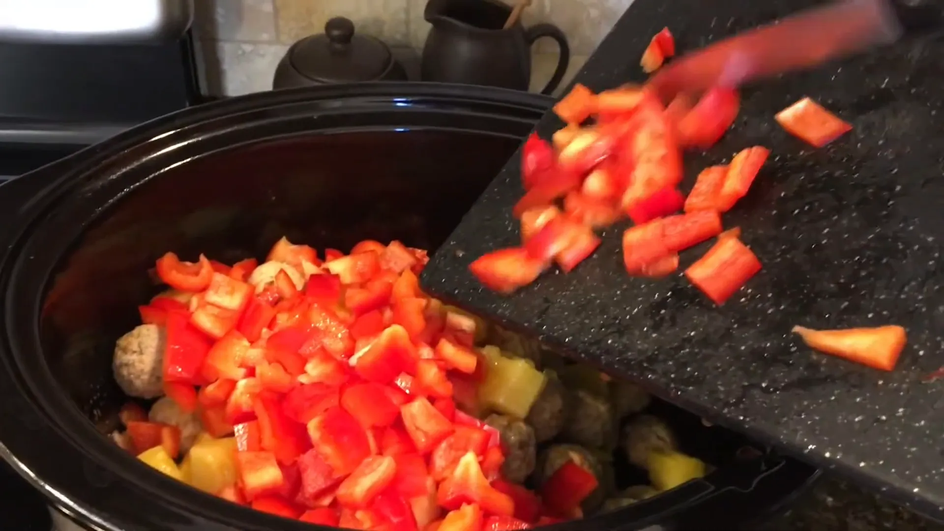 Bell peppers mixed with meatballs and pineapple.