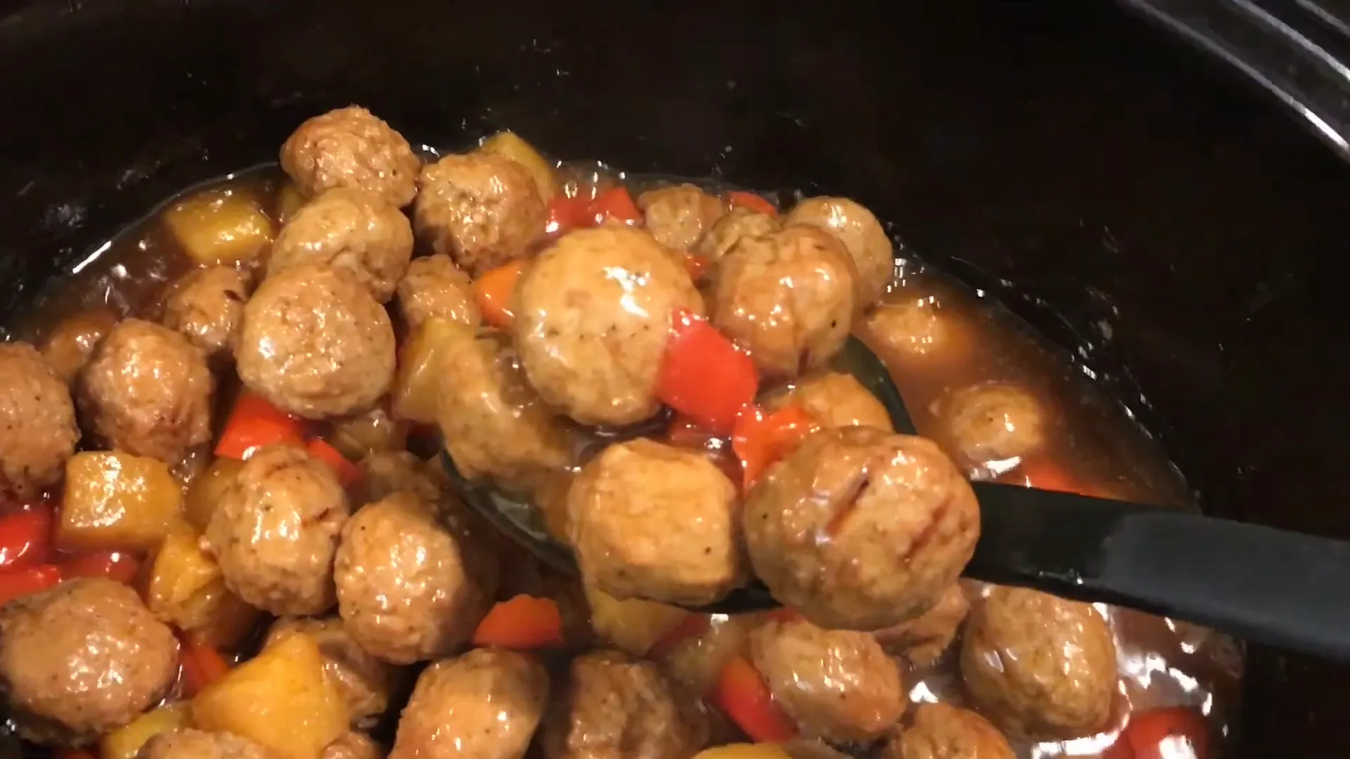 Serving Hawaiian meatballs over rice.