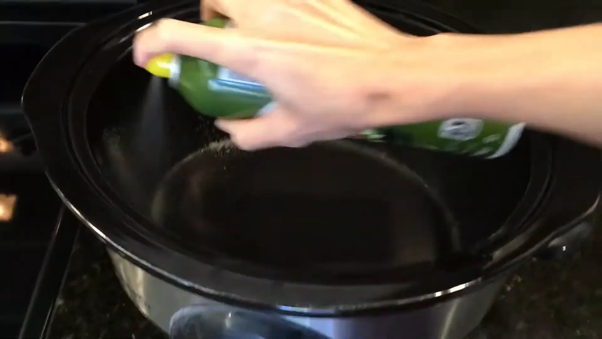 Spraying the crockpot with nonstick cooking spray.