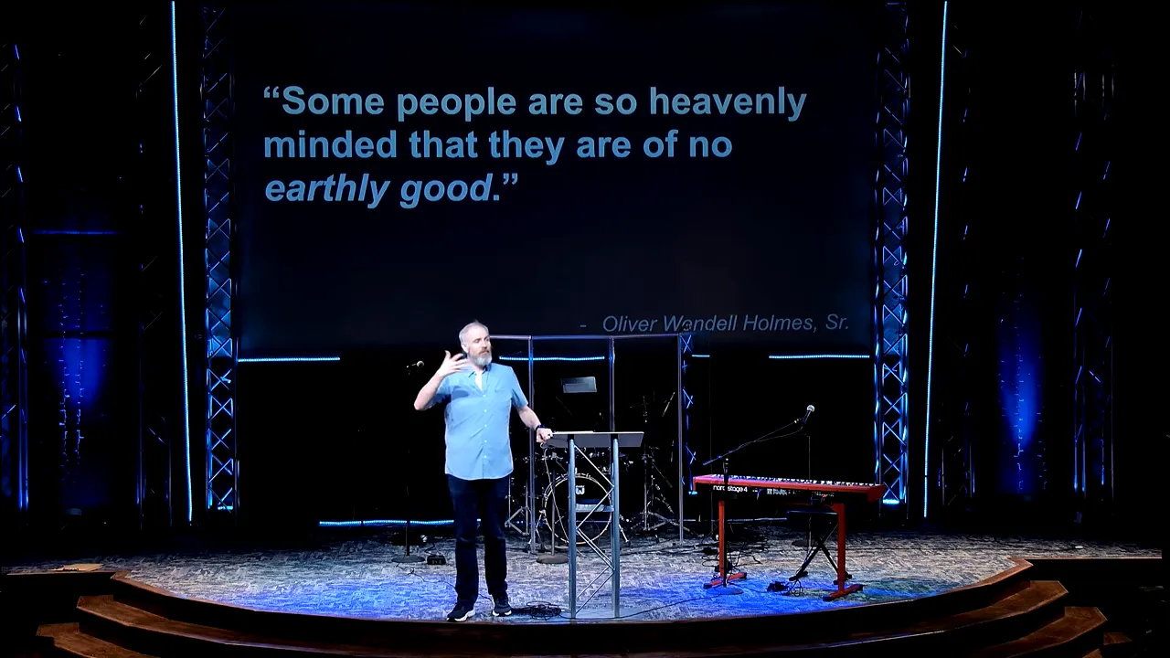 Church speaker with hands open during sermon, with quote about heavenly-minded goodness