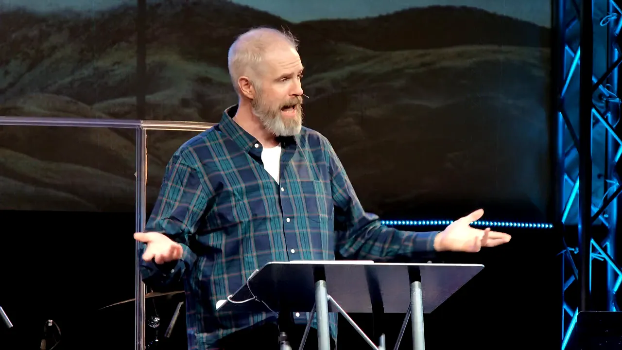 Close-up of a pastor speaking passionately at a lectern during a sermon.