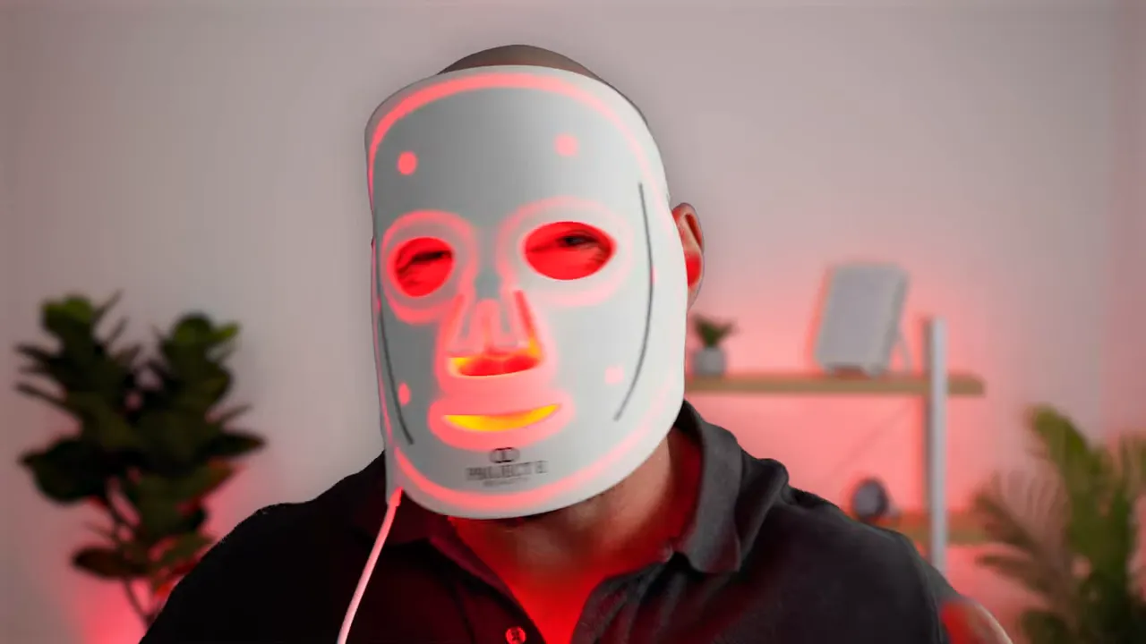 Person wearing Project E LumaLux Pro LED face mask with red lights on, showing full coverage