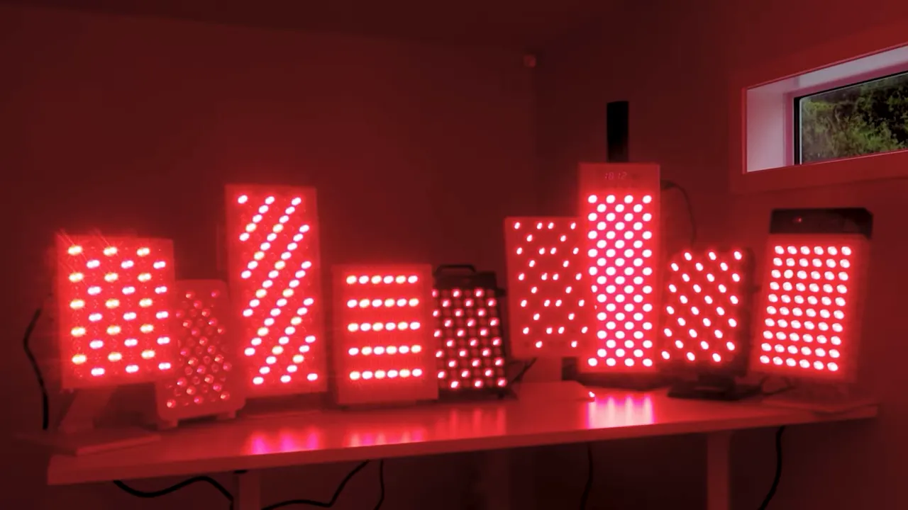 Array of red light therapy panels glowing red on a shelf