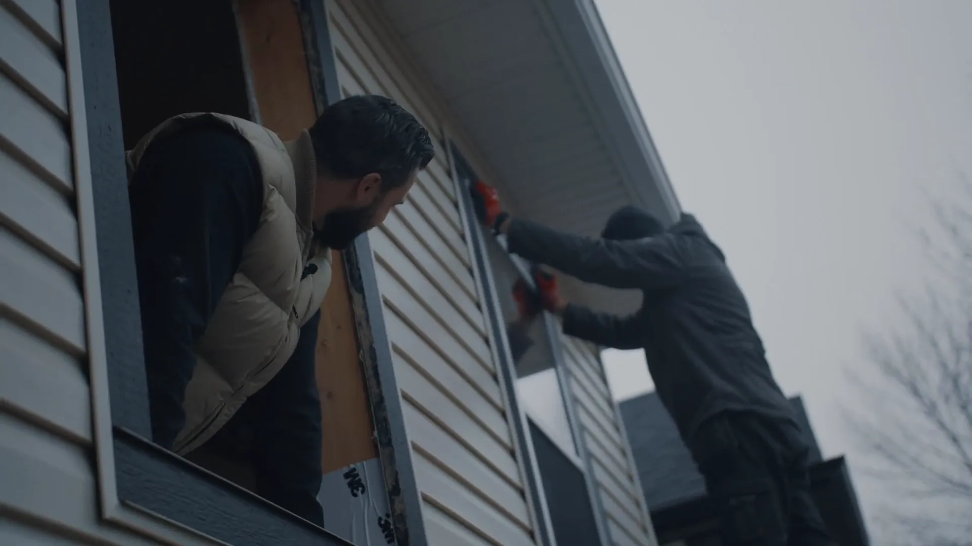 A Calgary home inspector is testing the kitchen sink for safe water temperatures and possible signs of leaks.