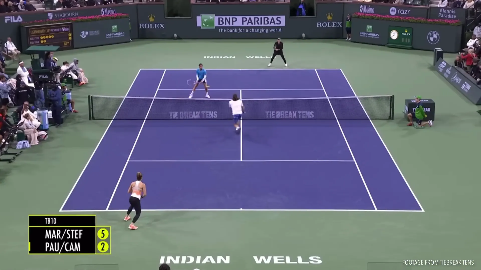 Net player volleying low at the opponent's feet