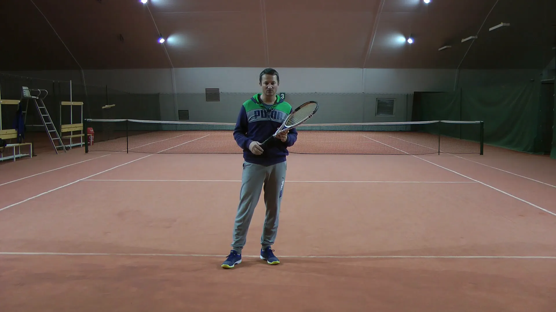Tennis coach explaining the importance of balance in stroke correction