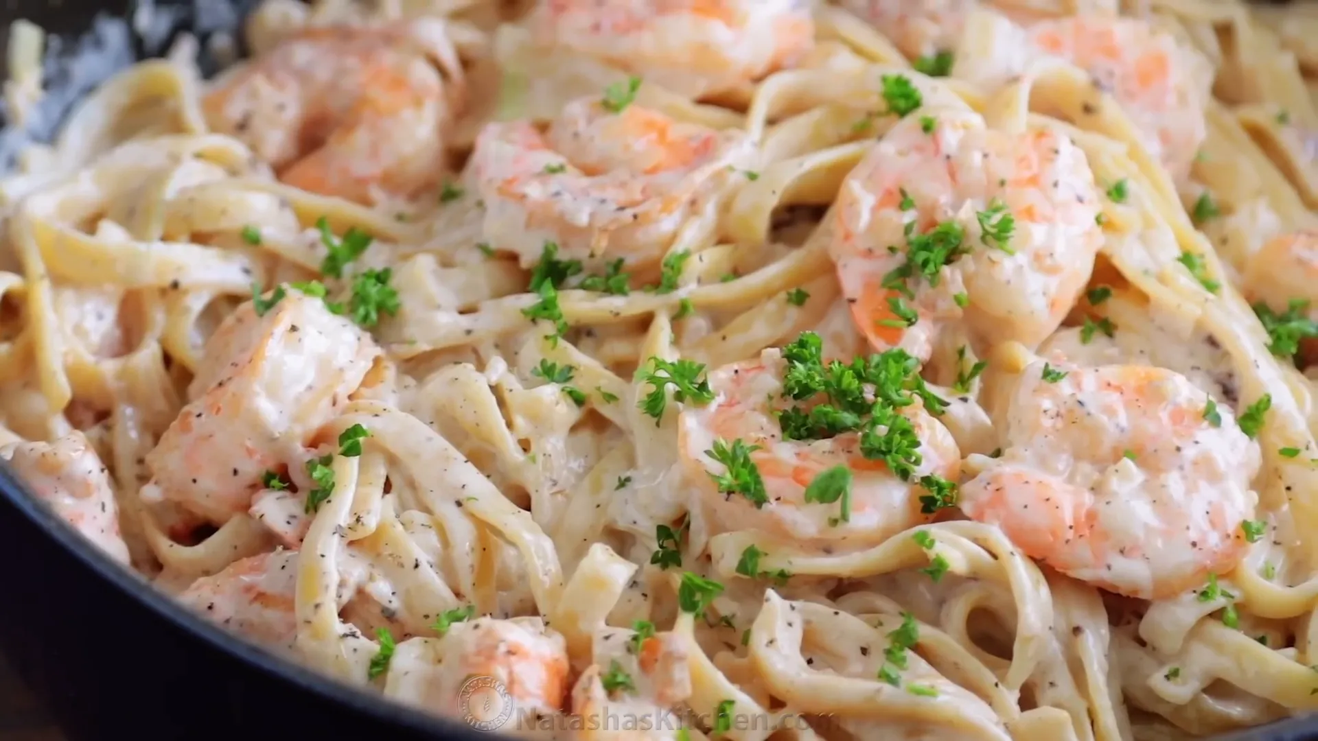 Garnishing the pasta with fresh parsley