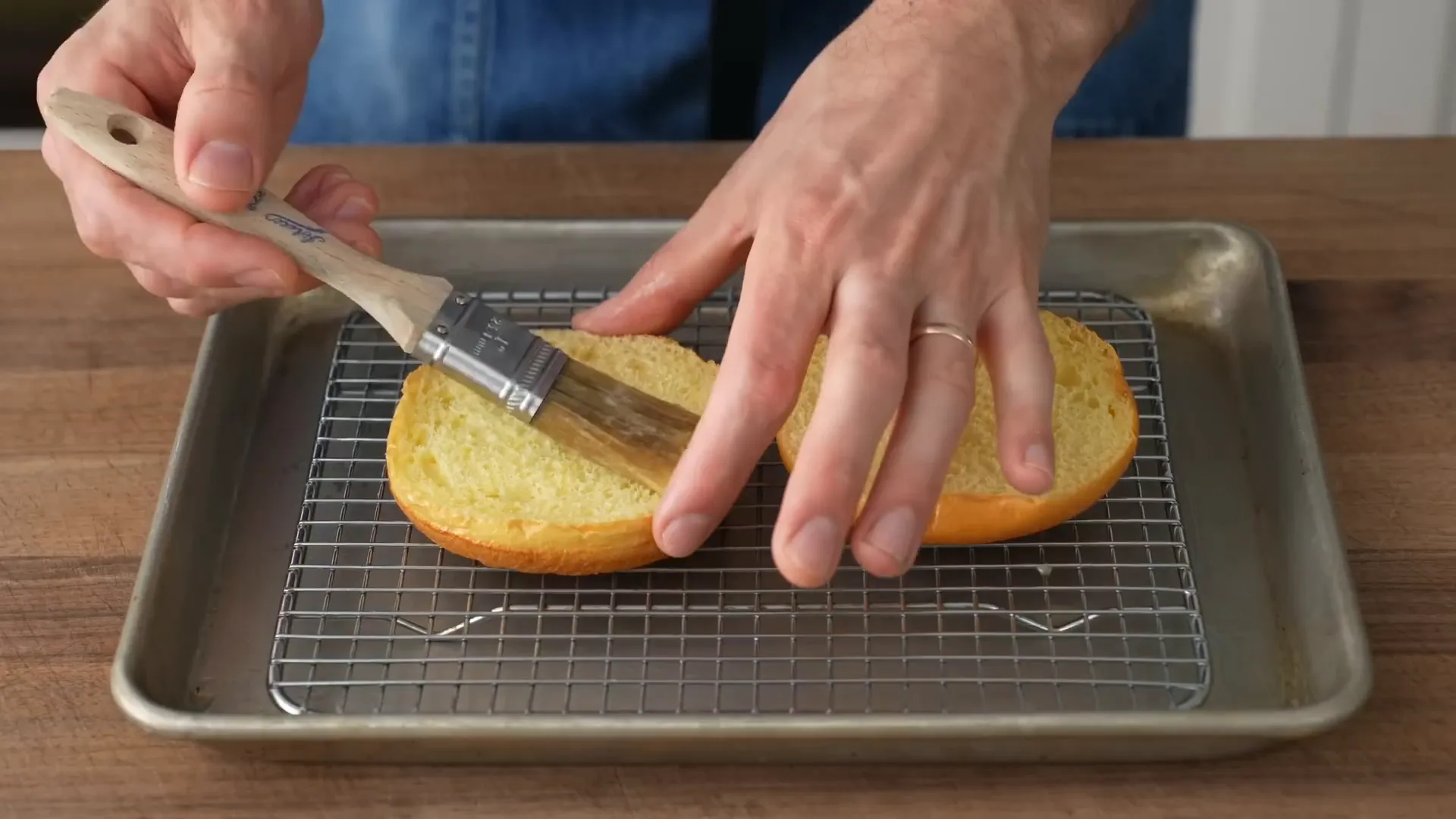 Brushing butter on the bun