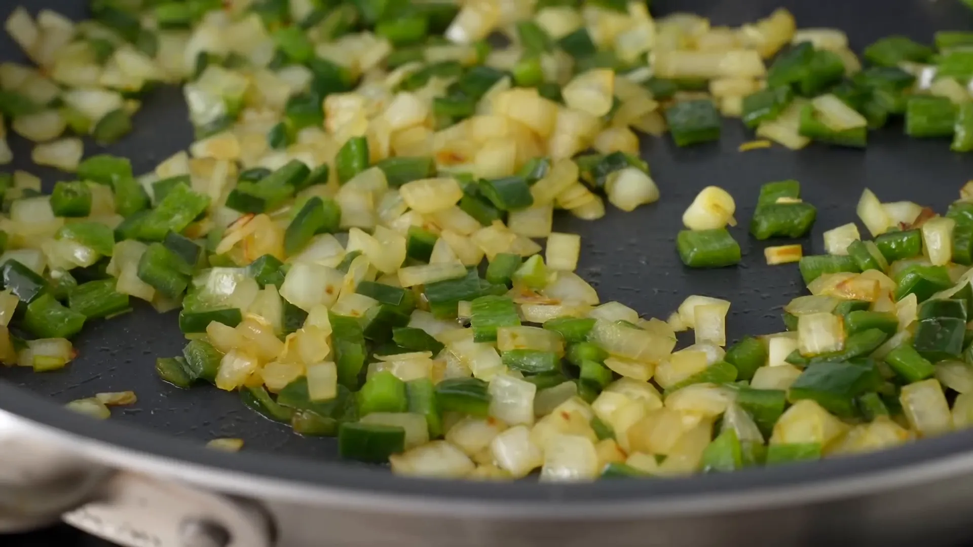 Adding cooked vegetables to the pan