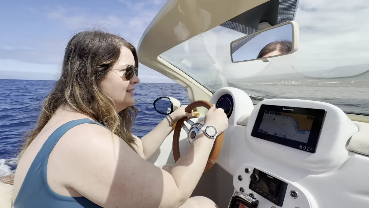 Driving a self-drive Fiat 500 boat in Tenerife beside the dashboard screen