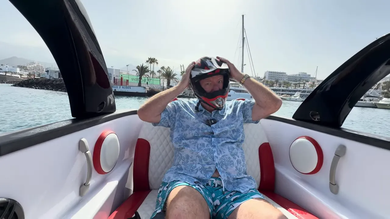 Rider adjusting helmet on the Fiat 500 Abarth speed boat during the Tenerife excursion