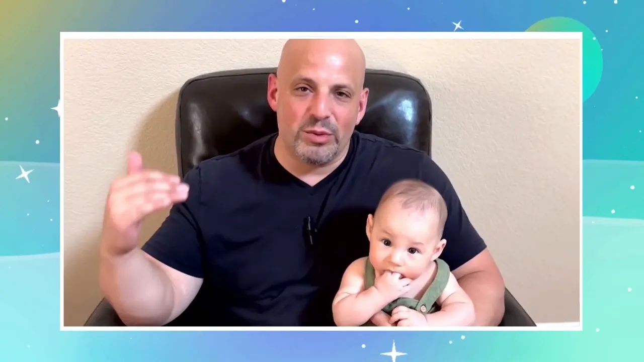 clear framed shot of presenter seated in chair holding a baby while addressing the viewer