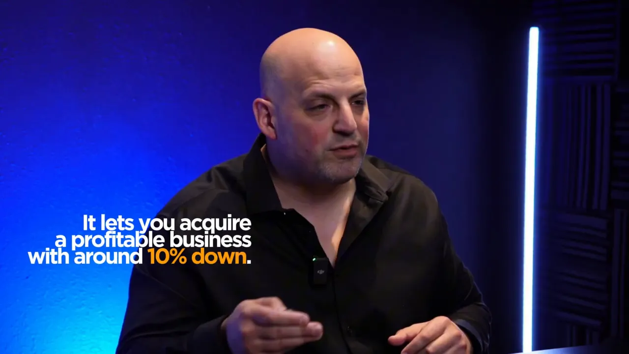 Presenter on a blue background with on-screen text: 'It lets you acquire a profitable business with around 10% down.'